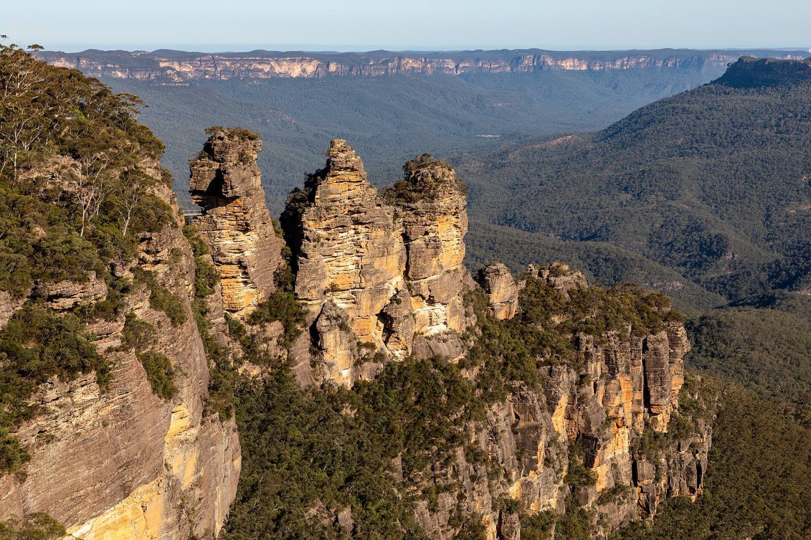 The Three Sisters rock formation above the forested Jamison Valley in the Blue Mountains