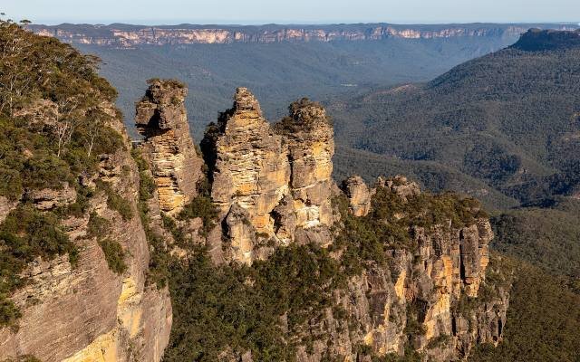 The Three Sisters rock formation above the forested Jamison Valley in the Blue Mountains