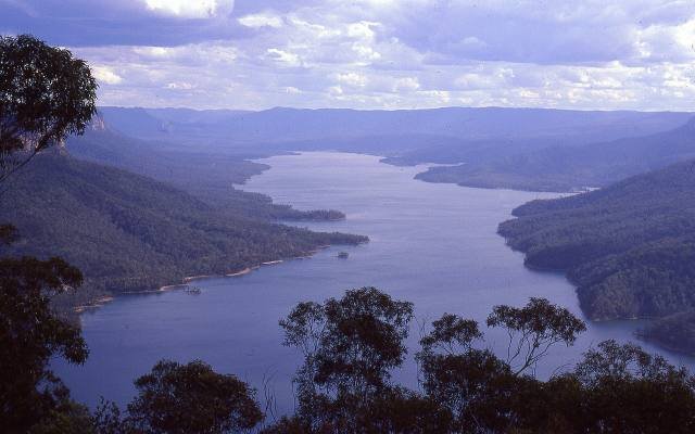 Lake Burragorang in afternoon light between forested ridges, seen from Burragorang Lookout