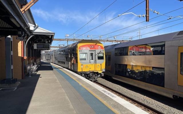 A double-deck intercity train leaving Campbelltown station