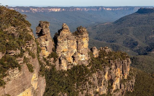 The Three Sisters rock formation above the forested Jamison Valley in the Blue Mountains