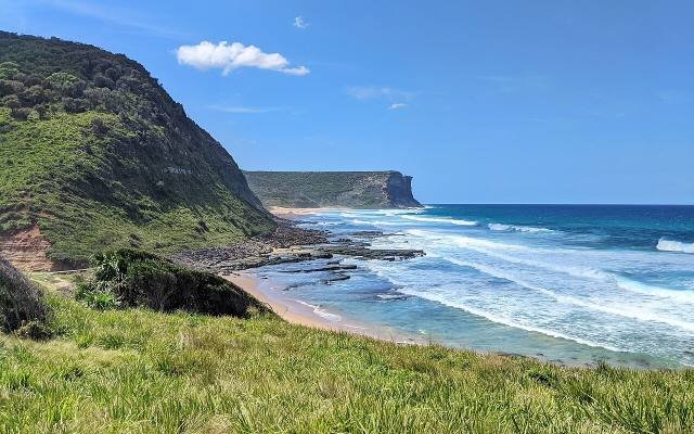 Garie Beach curving below green headlands in the Royal National Park